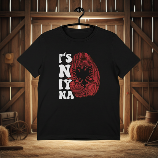 Black t-shirt with red and white graphic design on a barn background